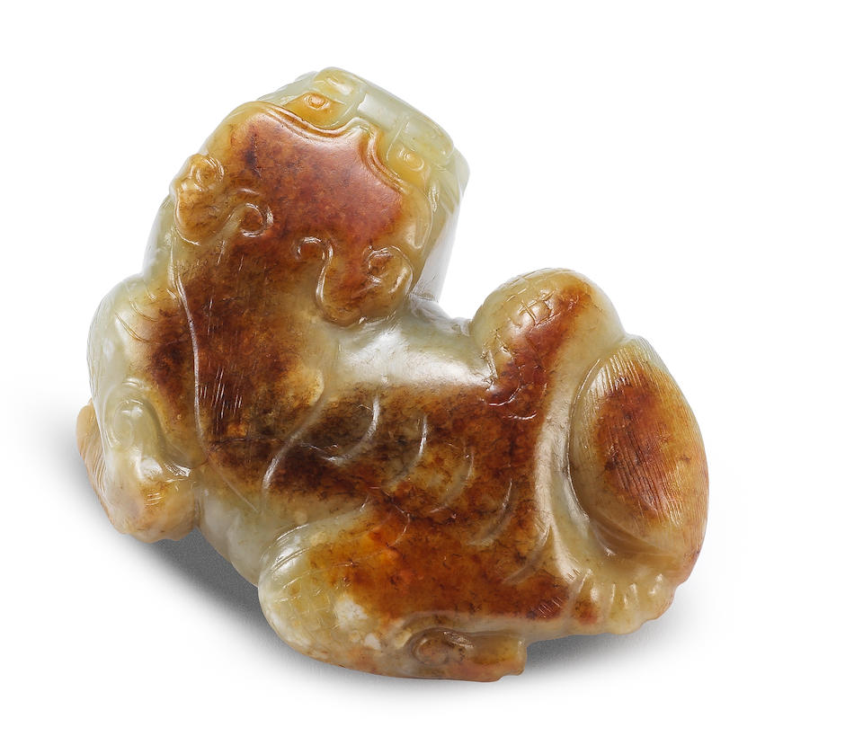 Bonhams : A very rare pale green and russet jade carving of a mythical ...