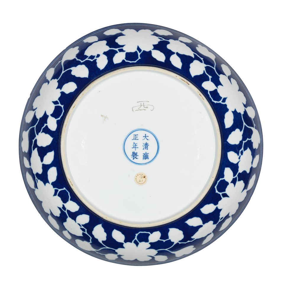 A reserved-decorated blue-ground 'floral' dish Yongzheng six-character mark and of the period