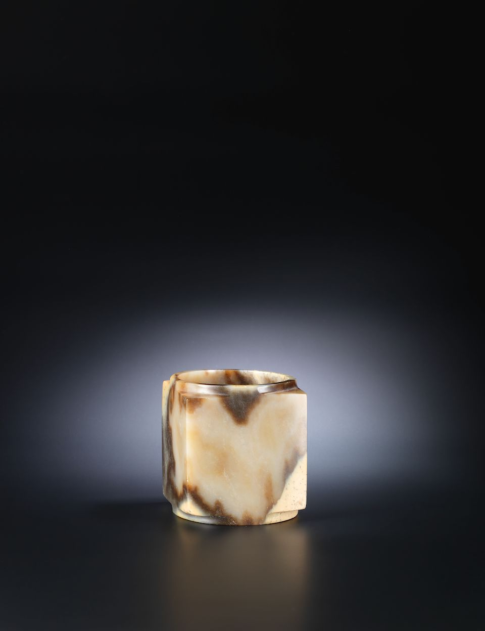 A mottled yellow and brown jade cylindrical vessel, cong Neolithic Period or later