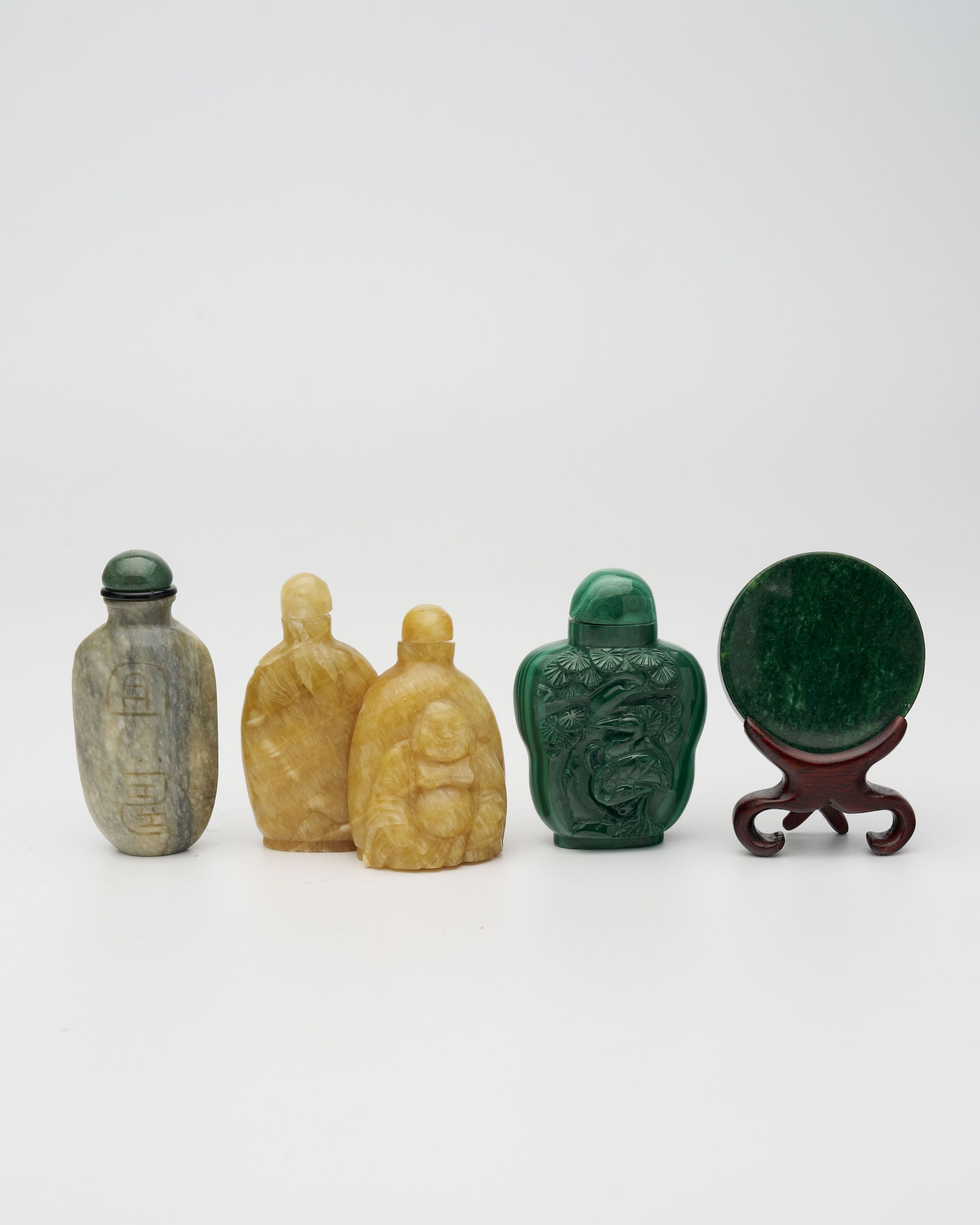 A YELLOW JADE, A HARDSTONE, A MALACHITE SNUFF BOTTLE AND A SNUFF DISH 20th century