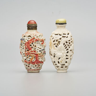 TWO MOULDED AND ENAMELLED PORCELAIN 'DRAGON AND PHOENIX' SNUFF BOTTLES One with Qianlong six-character mark, mid Qing Dynasty (2)