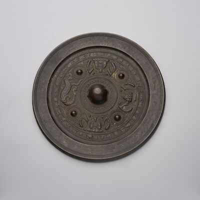 A BRONZE 'FIGURES AND MYTHICAL ANIMALS' MIRROR Western Han Dynasty