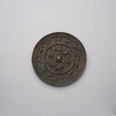 A BRONZE 'SEA CREATURES AND GRAPES' MIRROR Tang Dynasty