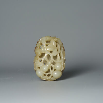 A RETICULATED PALE GREEN JADE 'SQUIRREL AND DOUBLE GOURD' PENDANT 19th century