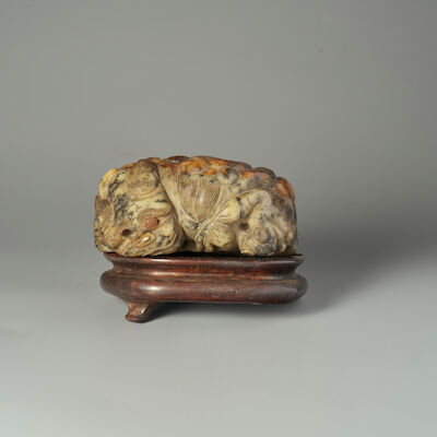 A GREEN AND RUSSET JADE 'BUDDHIST LION' BOULDER 19th century