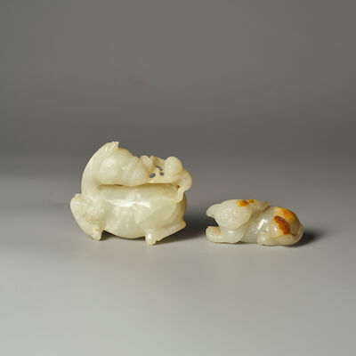TWO GREENISH WHITE JADE CARVINGS OF A MONKEY RIDING A HORSE, AND A DOG 19th/20th century (2)