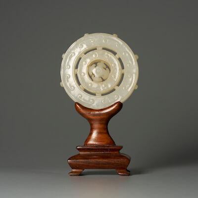 A WHITE JADE 'DHARMACHAKRA' PENDANT 18th century