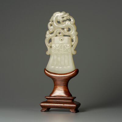 A GREENISH WHITE JADE 'DRAGON AND AXE' PENDANT 19th century