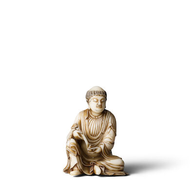 A CARVED SOAPSTONE FIGURE OF A LUOHAN