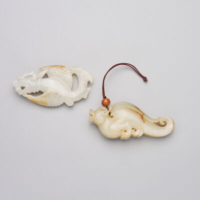 TWO GREENISH WHITE JADE TOGGLES OF MAKARA 19th/20th century (2)