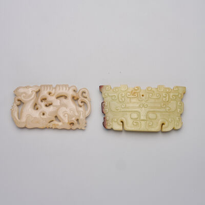 A GREEN JADE 'TAOTIE' AND A PALE GREY JADE 'CAMEL' PLAQUE 19th/20th century (2)