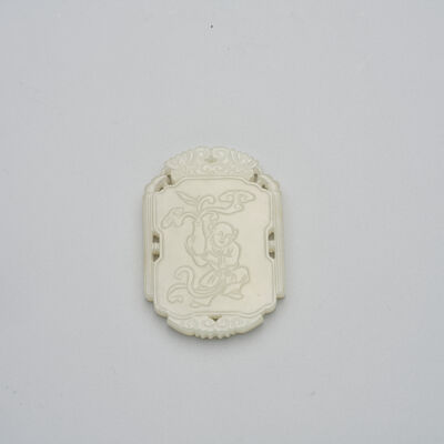 A WHITE JADE 'DANCING BOY' PENDANT 19th/20th century