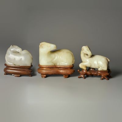 A WHITE JADE 'HORSE' AND TWO JADE 'GOAT' CARVINGS 19th/20th century (3)