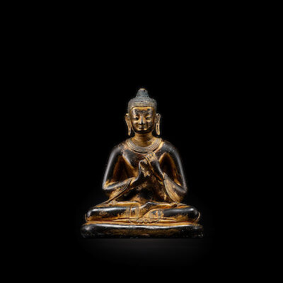 A GILT COPPER ALLOY FIGURE OF BUDDHA NEPAL OR TIBET, 16TH/17TH CENTURY