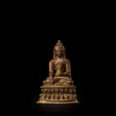 A GILT COPPER ALLOY FIGURE OF BUDDHA TIBET, 14TH CENTURY