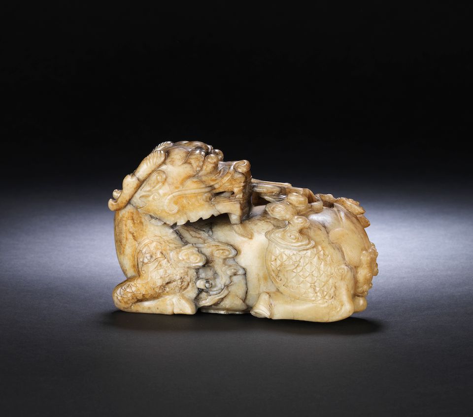 A superb large grey and pale yellow jade carving of a qilin 17th century