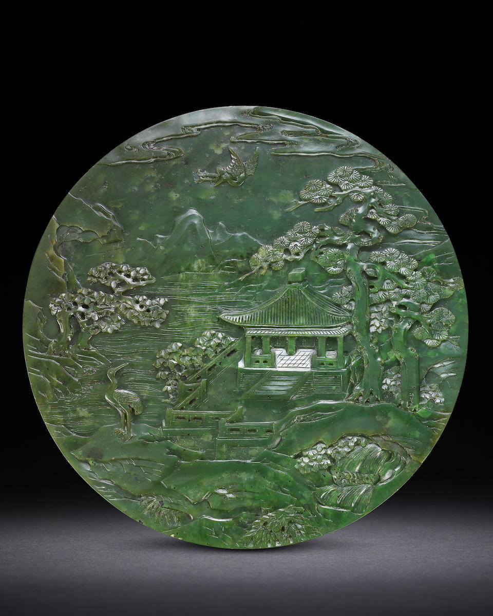 A rare spinach-green jade 'Laozi passing through the Hangu Pass' double-sided circular screen Early 19th century