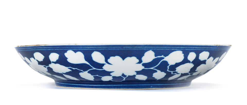 A reserved-decorated blue-ground 'floral' dish Yongzheng six-character mark and of the period