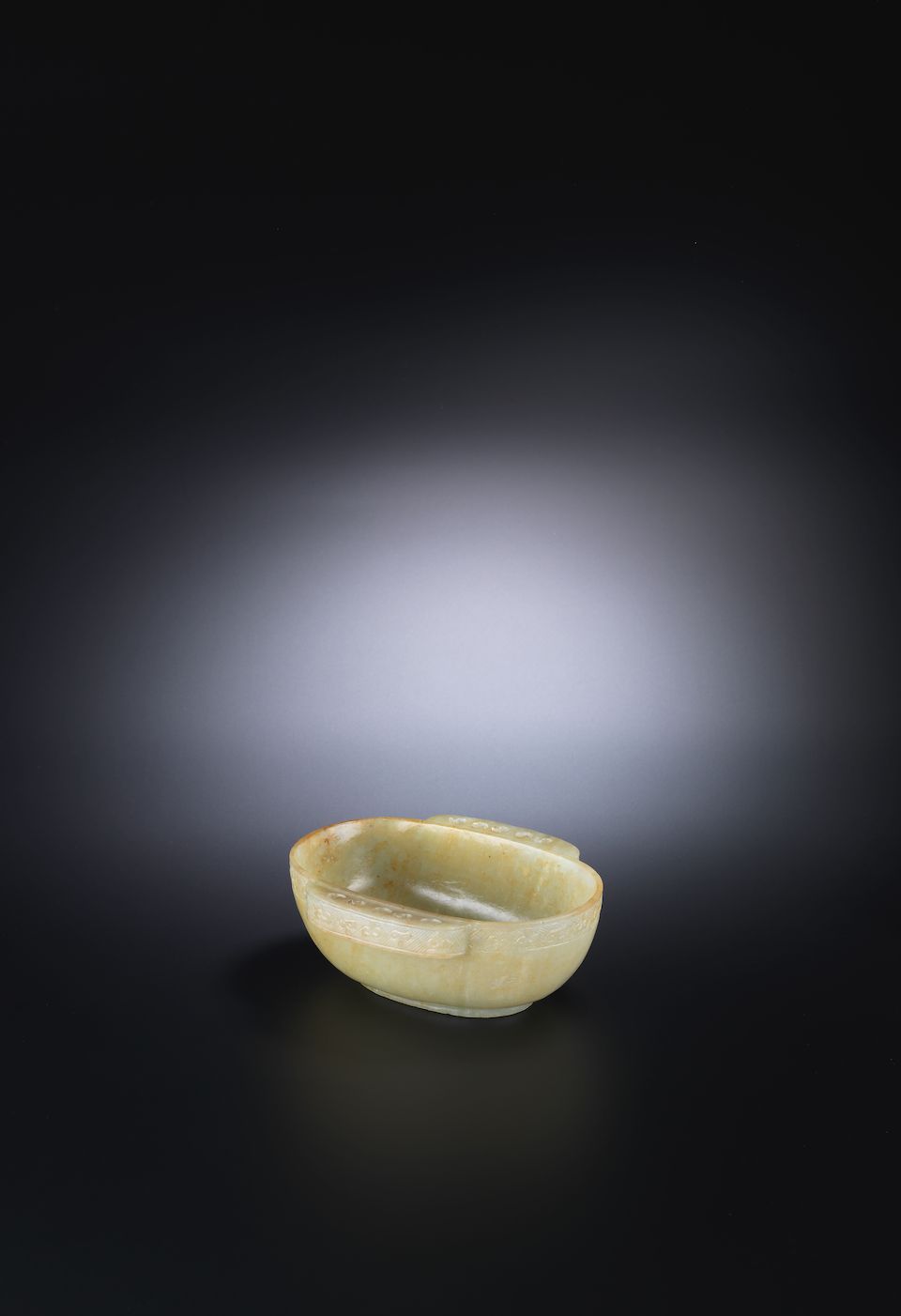 A pale green jade archaistic ear cup 17th/18th century