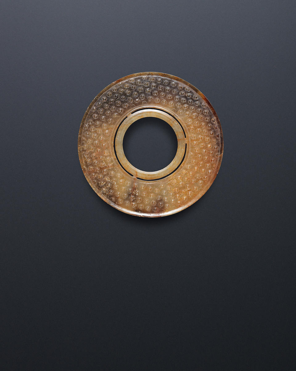 A yellow and brown jade double disc, bi Western Han Dynasty