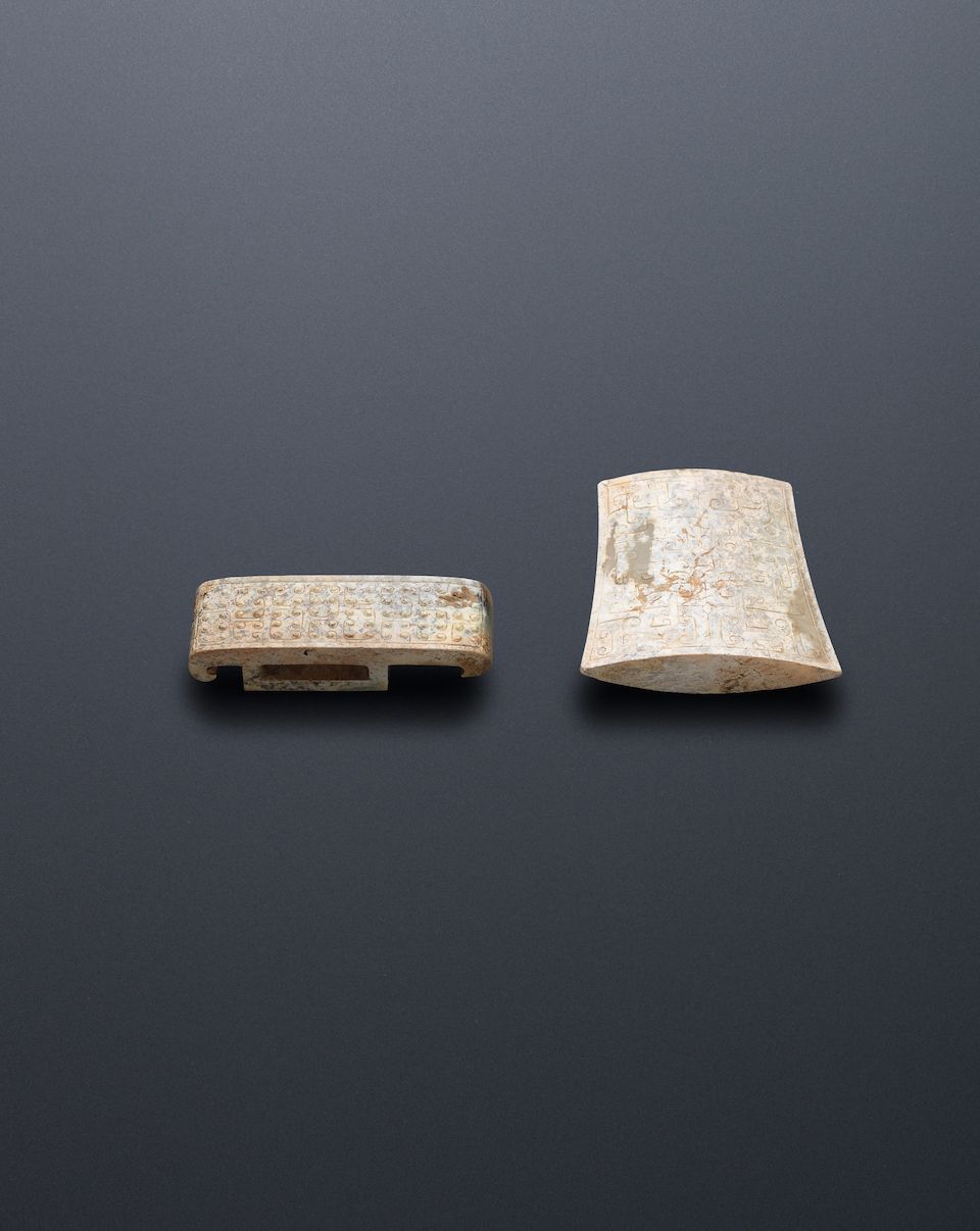 A jade plaque, huang; together with two jade sword fittings Warring States Period (3)