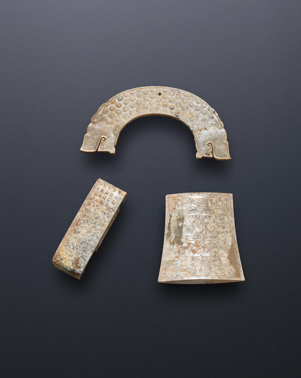 A jade plaque, huang; together with two jade sword fittings Warring States Period (3)