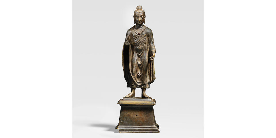 AN INSCRIBED BRASS ALLOY FIGURE OF STANDING BUDDHA ANCIENT REGION OF GANDHARA, CIRCA 6TH CENTURY