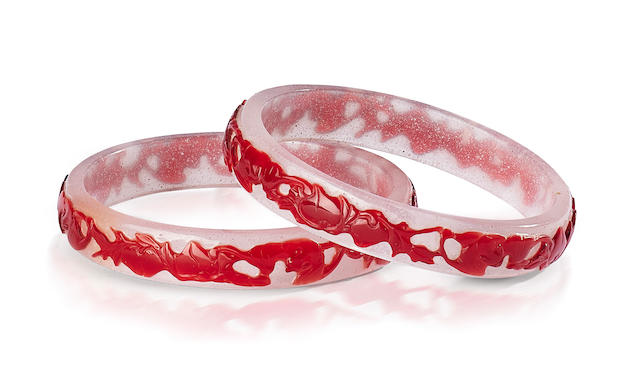 A PAIR OF RED OVERLAY GLASS 'BATS AND PEACHES' BANGLES 19th century (2)