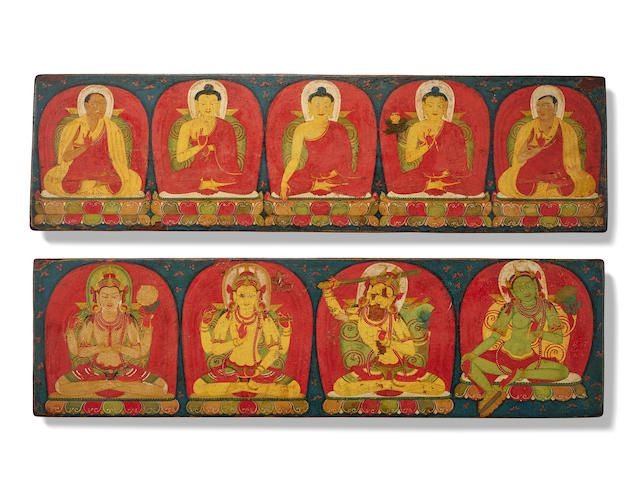 A PAIR OF CARVED AND PAINTED WOOD SUTRA COVERS CENTRAL TIBET, 13TH CENTURY