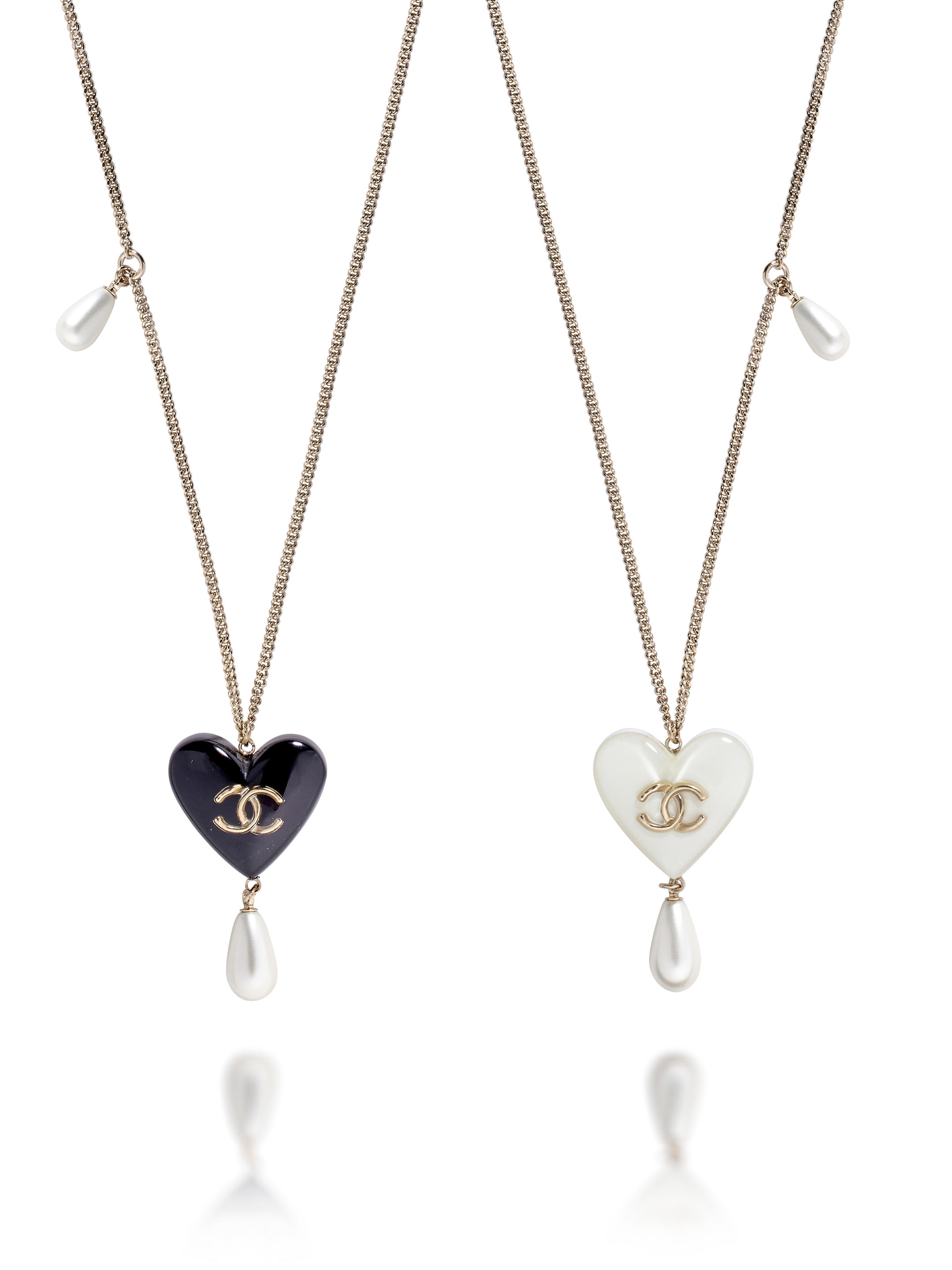 Bonhams : CHANEL WHITE AND BLACK HEART PENDANTS NECKLACE IN GOLD