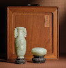 Thumbnail of A SMALL PALE GREEN JADE ARCHAISTIC VASE, A CIRCULAR PALE GREEN JADE ARCHAISTIC BOX AND COVER Qing Dynasty image 1