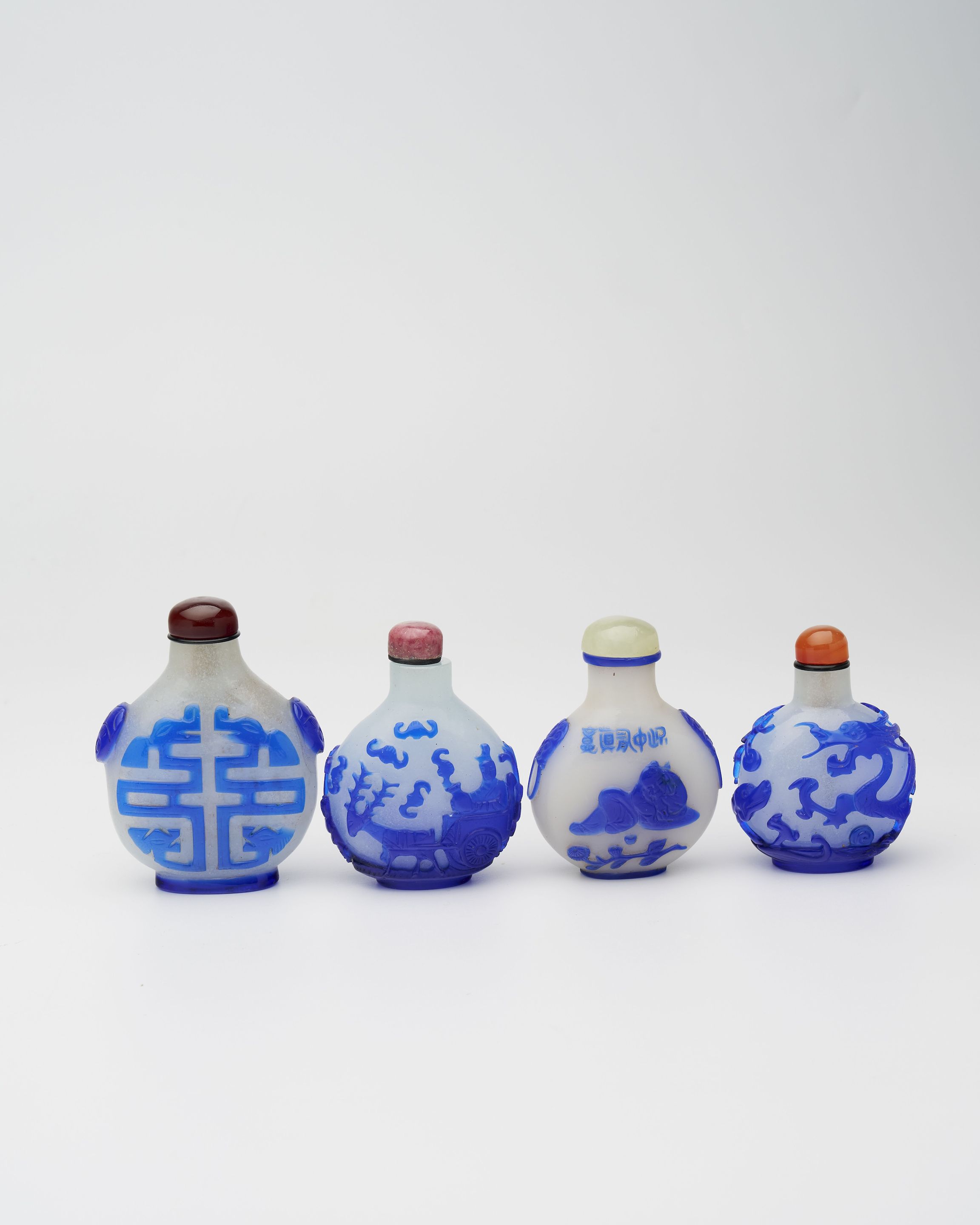 FOUR BLUE OVERLAY GLASS SNUFF BOTTLES 19th/20th century