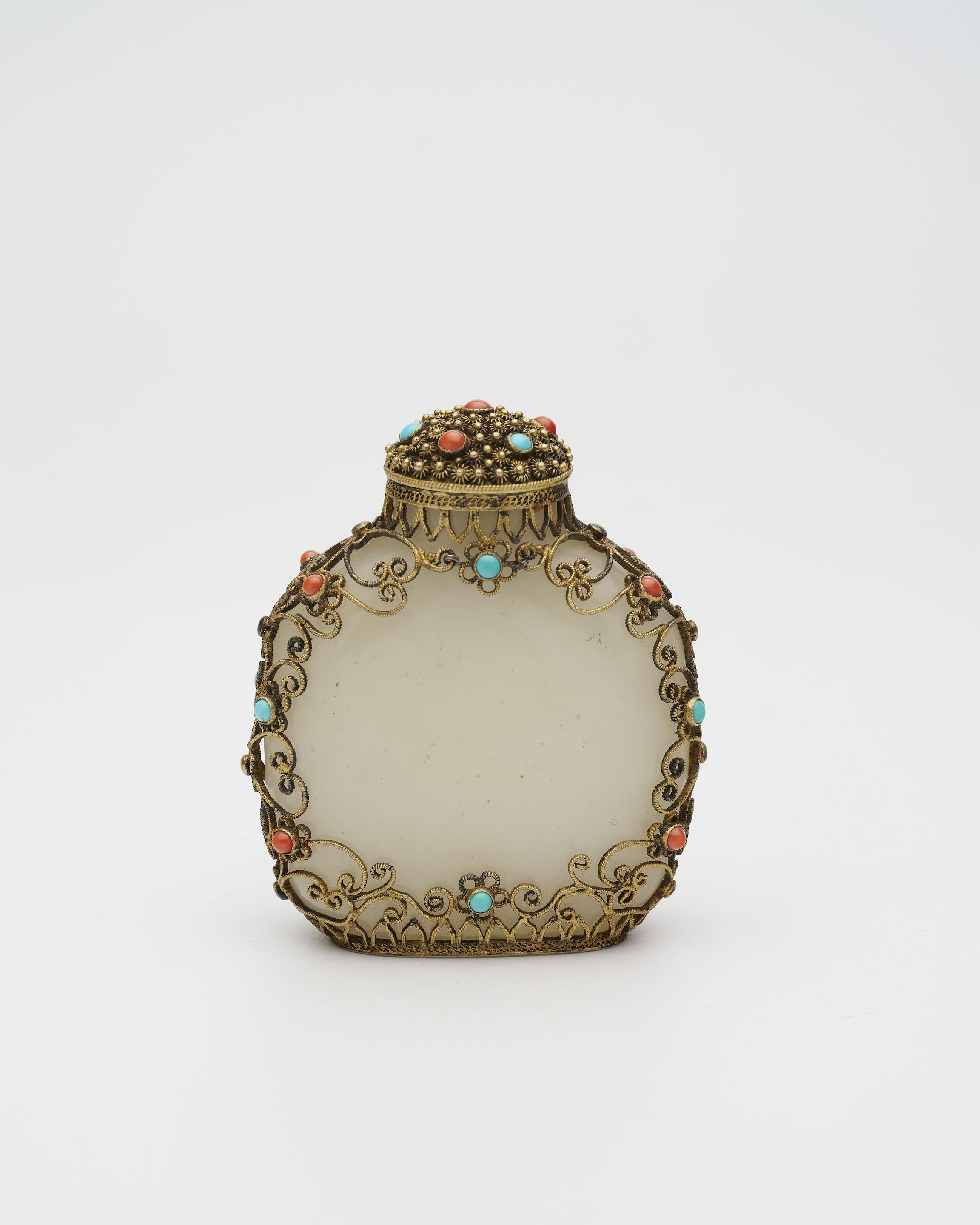 AN INLAID FILIGREE-MOUNTED WHITE JADE SNUFF BOTTLE The jade 18th/19th century, the gilt-metal filigree decoration 1955-1965