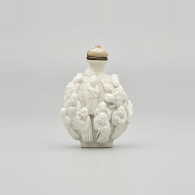A MOULDED BISCUIT PORCELAIN 'EIGHTEEN LUOHAN' SNUFF BOTTLE Jiaqing Period