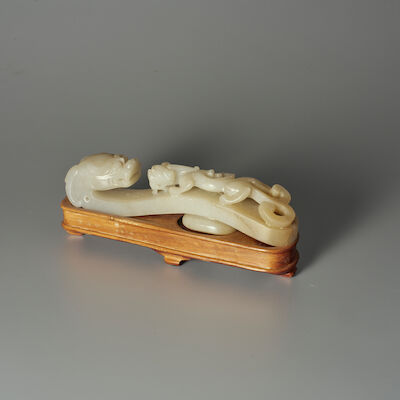 A PALE GREEN JADE 'CHI DRAGON' BELT BUCKLE 19th century