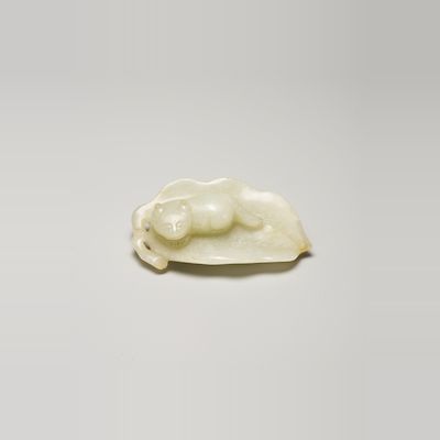 A PALE GREEN JADE PENDANT OF A CAT ON A LEAF 19th century
