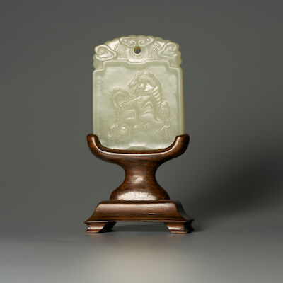 A GREENISH WHITE JADE 'BUDDHIST LION' PLAQUE 19th century