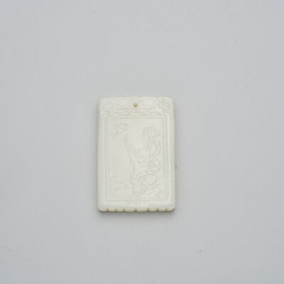 A WHITE JADE 'BOY AND BAT' PLAQUE 19th/20th century